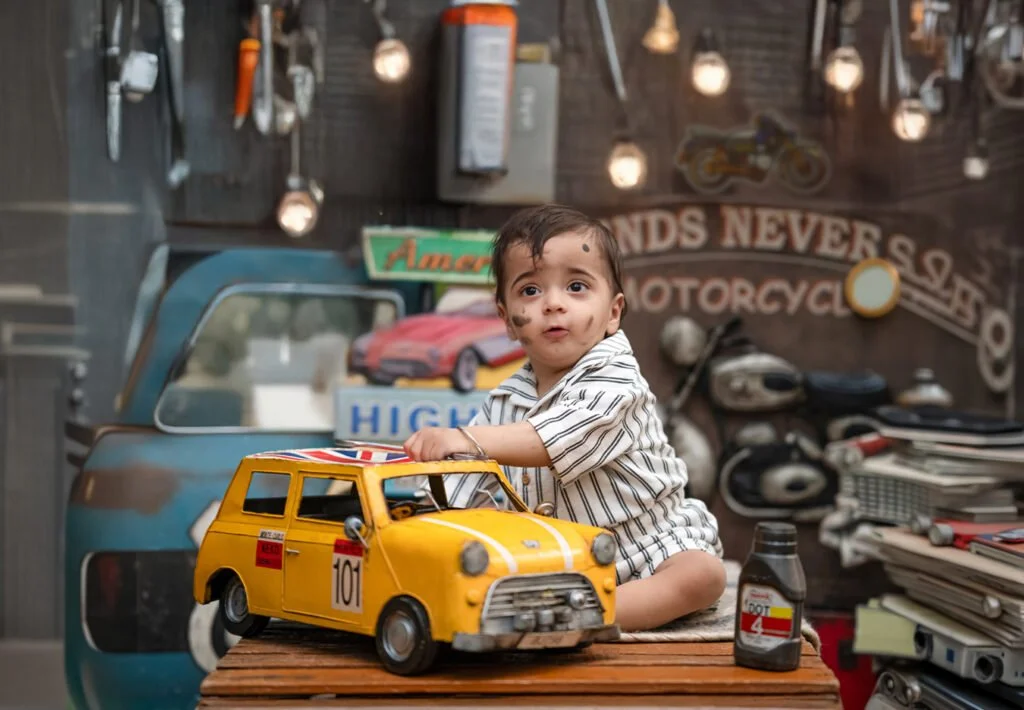 Cheerful baby playing during a sitter photography session with colorful props at Say Cheese studio Ranchi